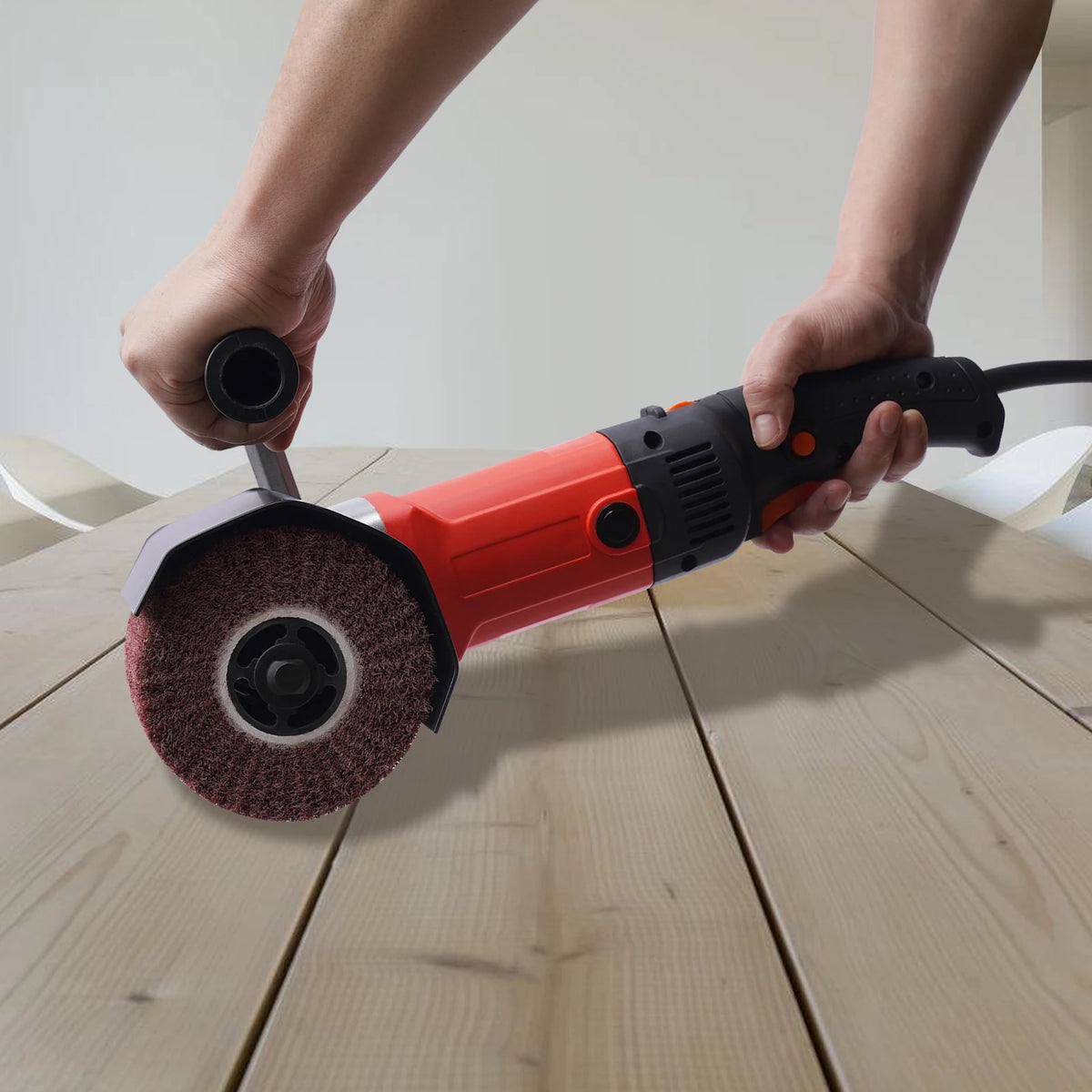 1400 W Grinder Brush in red and black, lifestyle shot outdoors